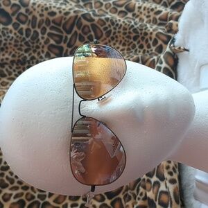 Ray-Ban aviator style sunglasses in a rose gold or nude color